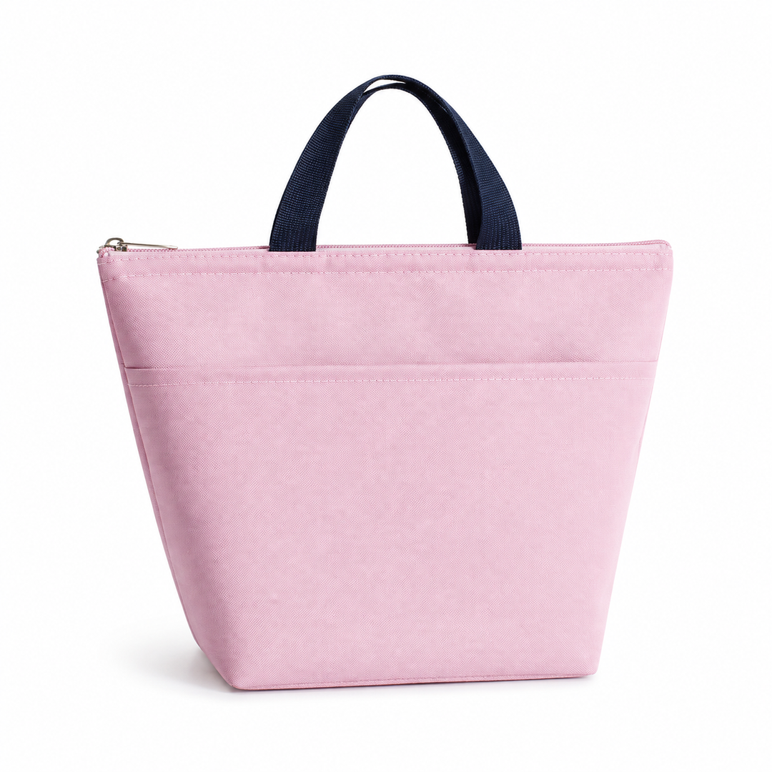Insulated bento lunch bag in soft pink with navy handles, zip closure, front pocket and clean white studio background display