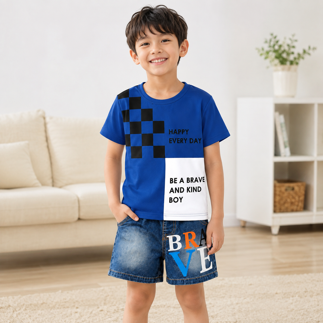 Young boy wearing navy graphic tee and denim shorts in a bright indoor setting, showing the coordinated kids outfit.