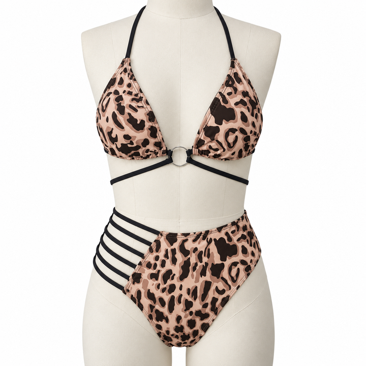 Leopard bikini on a fabric display mannequin against white, showing the halter neckline, center ring and black strap details.