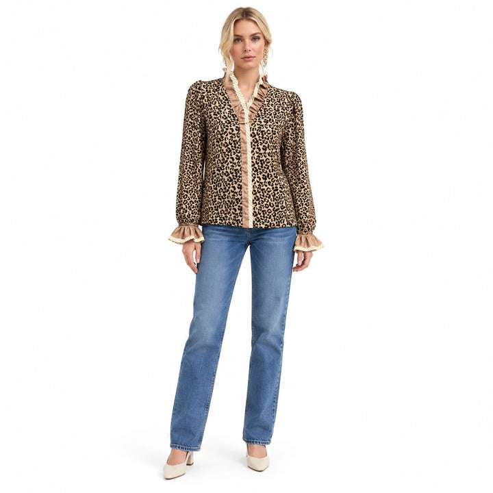 Leopard long sleeve top in Wild Leopard Elegance with beige ruffle trim, worn with blue jeans in full body white studio view.