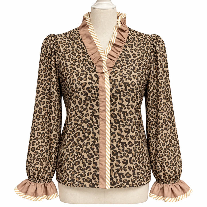 Wild Leopard Elegance blouse on a dress form, showing V-neck ruffles, striped trim, long sleeves and matching gathered cuffs.