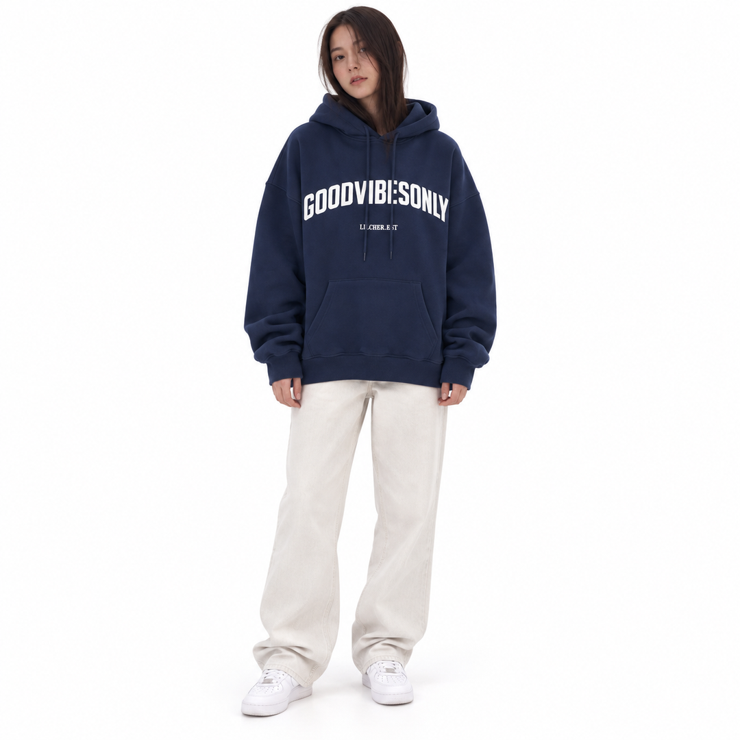 Navy blue letter print hoodie with chest print, drawstring hood and kangaroo pocket, shown on a brunette model against white.