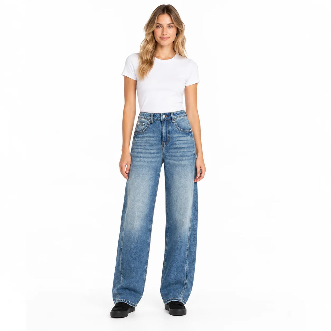 Light blue wide leg jeans on an adult woman in a white T-shirt, shown full length from front against a white studio backdrop.