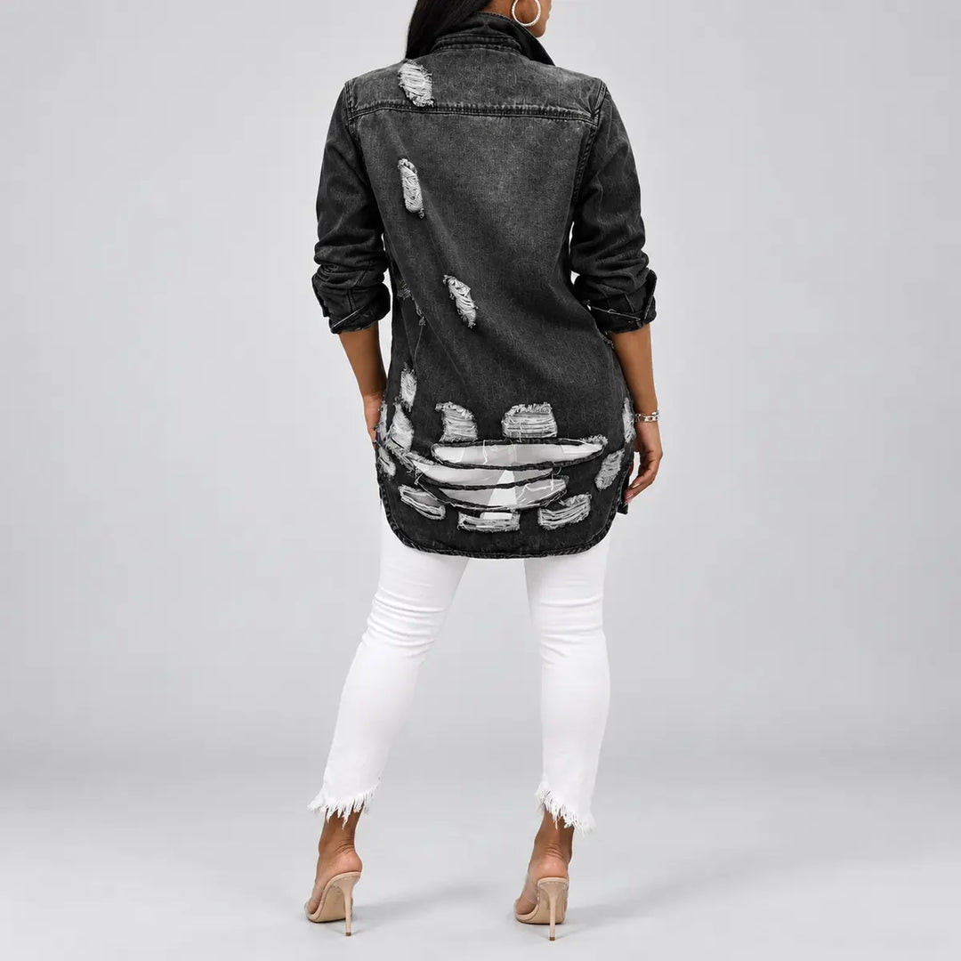 Full back view of longline denim jacket showing shoulder yoke, scattered ripped sections and a heavily distressed lower panel