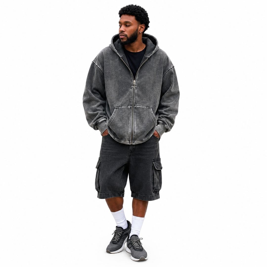 Men's zip up hoodie in washed charcoal shown on a male model with full front zipper, hood, front pockets and ribbed trim fit.