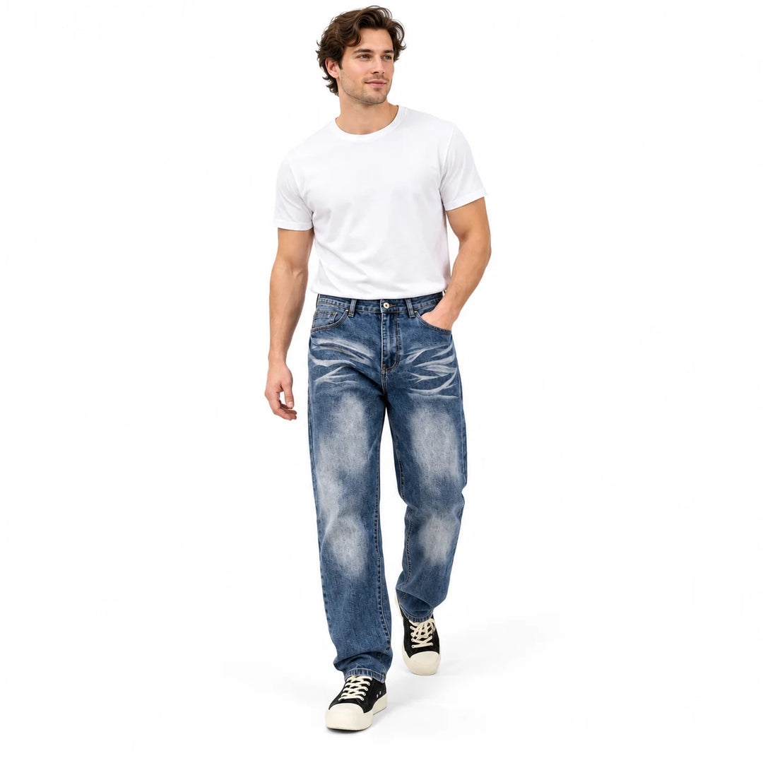 Walking male model wearing blue vintage washed straight-leg jeans, white T-shirt and black canvas sneakers in a white studio.