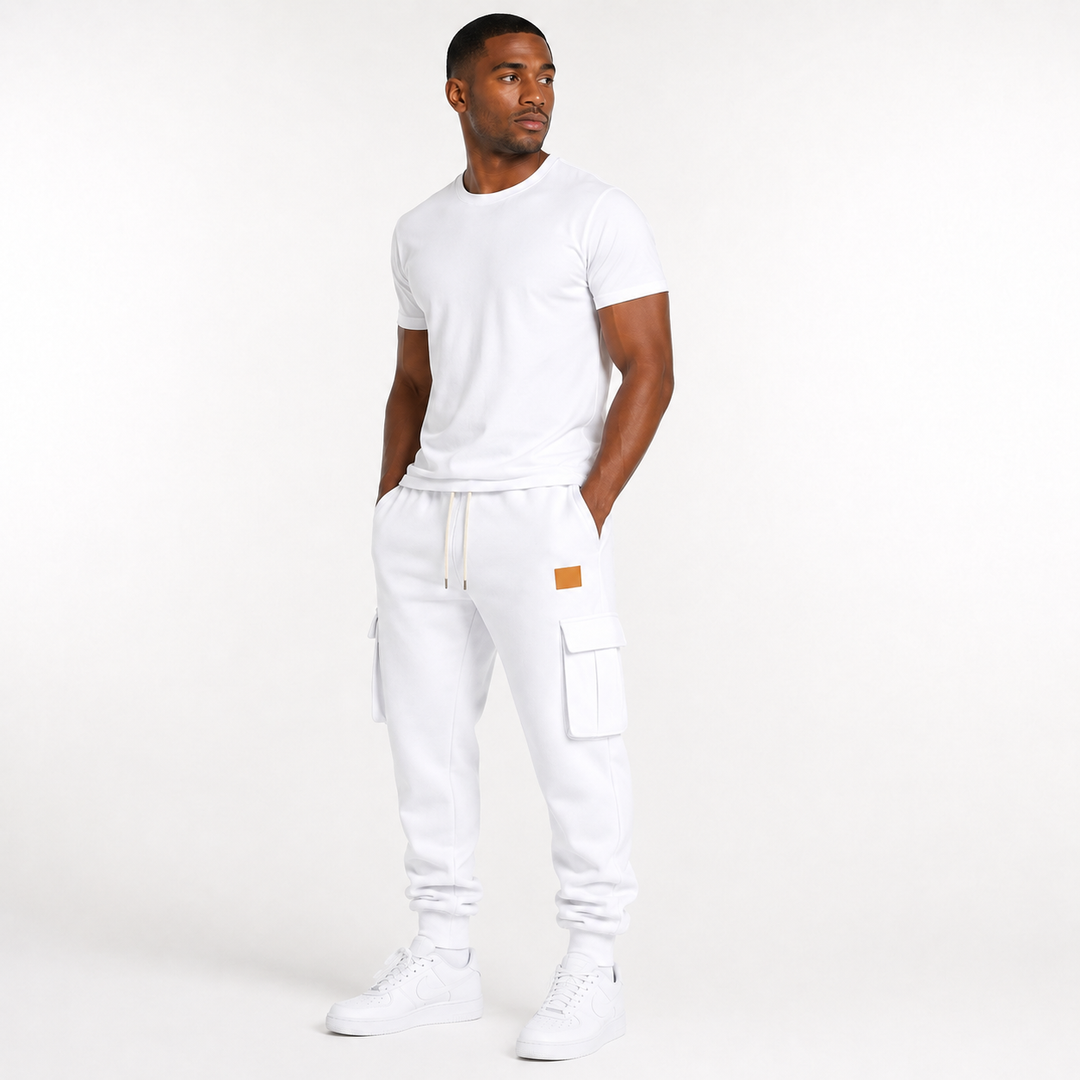 Male model wearing white cargo jogger pants with drawstring waist and cargo pockets on a clean white studio background.