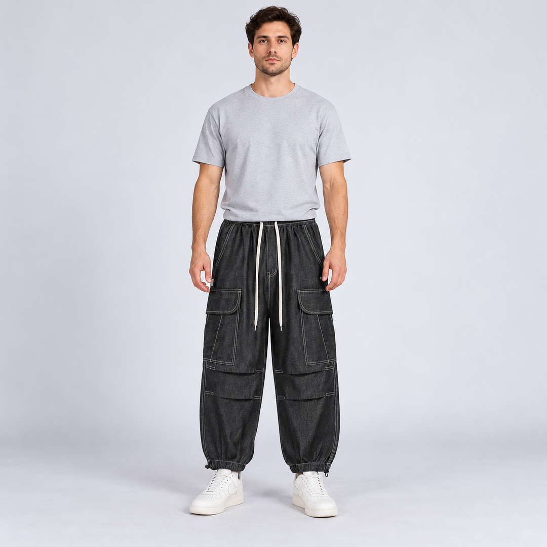 Front view of black cargo joggers with white drawstrings and contrast stitching on a full-body model.