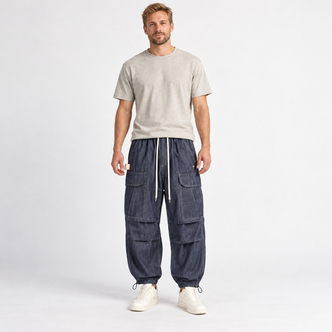 Front view of navy blue cargo joggers with white drawstrings on a full-body male model.
