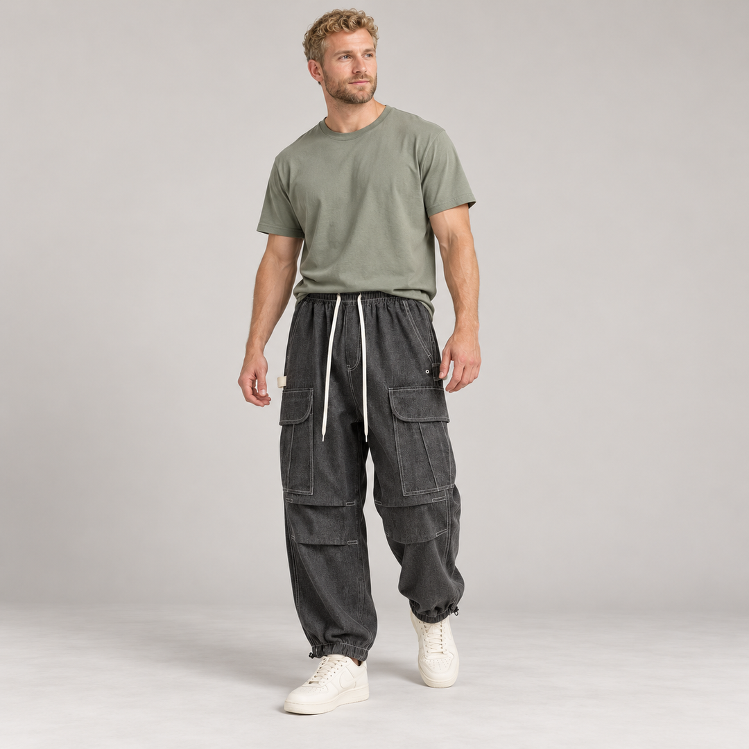 Full-body model wearing black cargo joggers with flap pockets and contrast stitching.