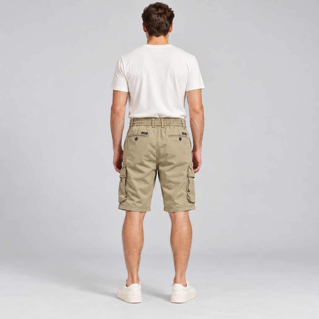 Back view of khaki cargo shorts with two buttoned rear pockets on a full-body model.