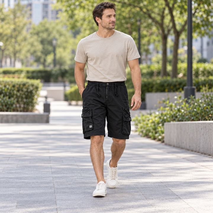 Full-body model walking in black cargo shorts with flap pockets.