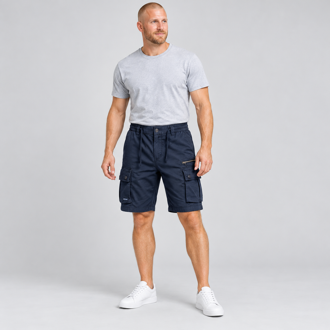 Dark blue cargo shorts on a full-body male model with a grey T-shirt.