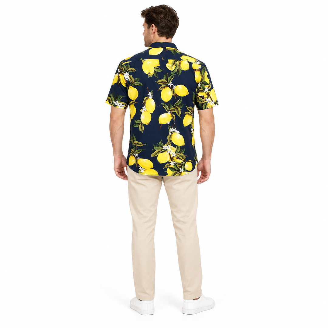 Model wearing a navy lemon print shirt shown from the back in a full-body studio photograph against a plain white background.