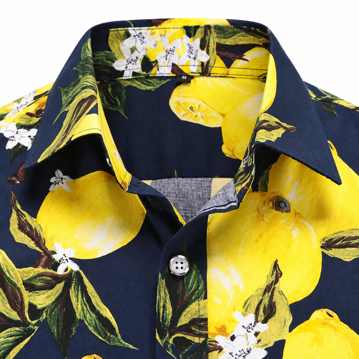 Close-up of the navy citrus print shirt collar and button, showing yellow lemons, green leaves and white floral print detail.