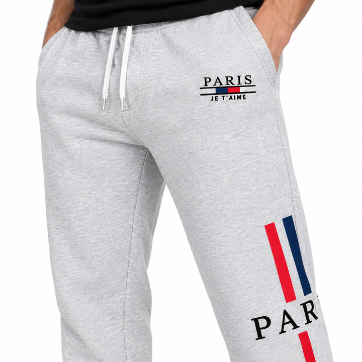 Close-up of grey Paris sweatpants showing Paris print, red and blue stripe graphic and pocket area