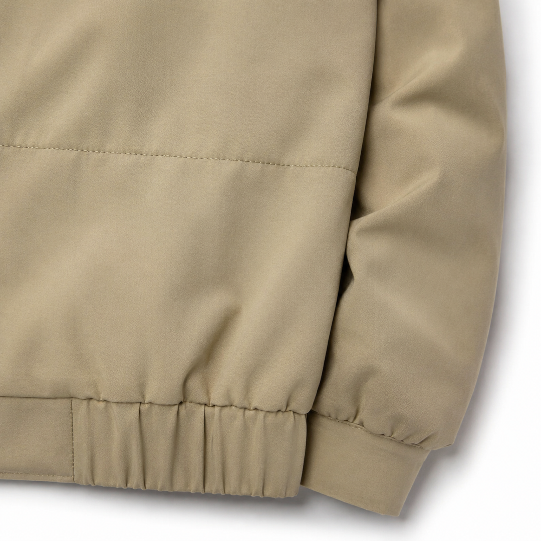 Khakis polyester jacket detail showing smooth fabric texture, neat stitching, horizontal yoke seam, and gathered elastic hem.
