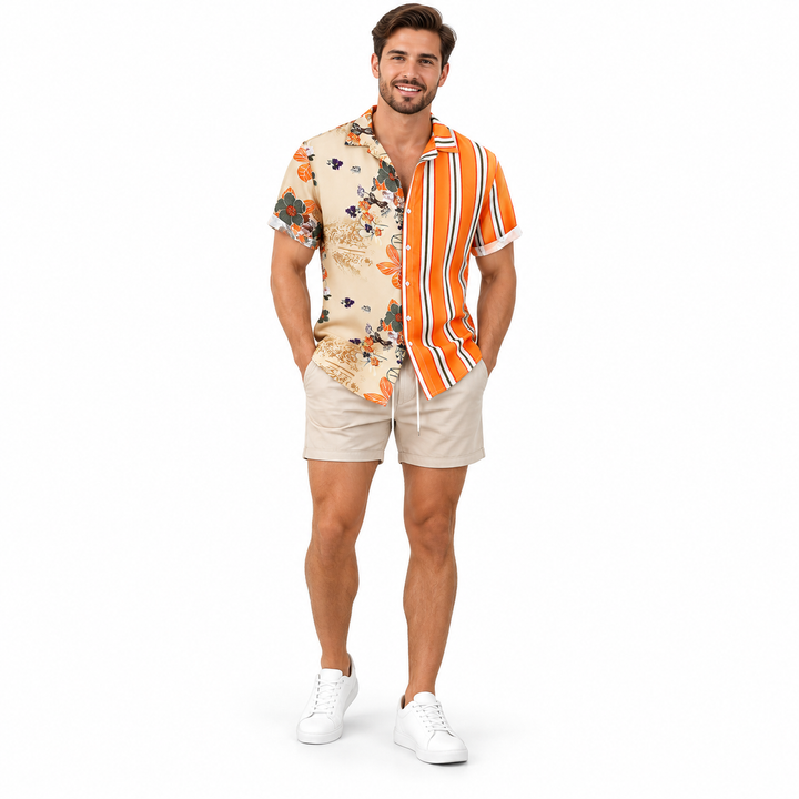 Full-body adult model wearing the orange stripe and cream floral short-sleeve button shirt with beige shorts and white shoes.