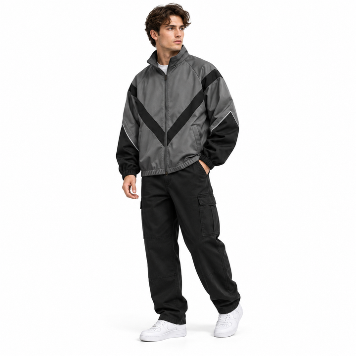 Three-quarter view of a male model in gray and black style 6618 jacket, showing the stand collar and chevron contrast panels.