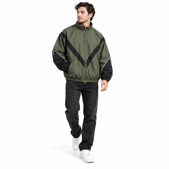Male model walking in olive green with black style 6618 jacket with chevron contrast panels and stand collar, shown on white.