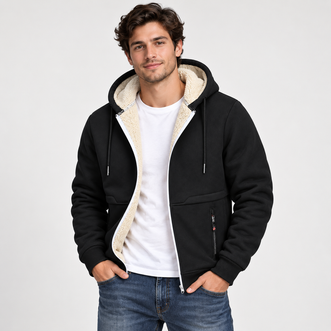 Male model wearing the black sherpa-lined zip hoodie with cream lining, white T-shirt and blue jeans in a clean studio.