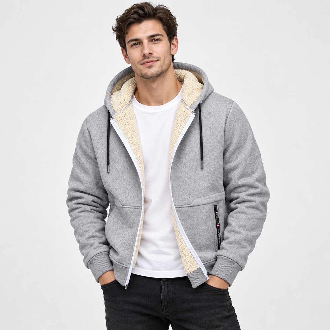 Male model wearing the light gray sherpa-lined zip hoodie with cream lining and white T-shirt in a clean studio setting.