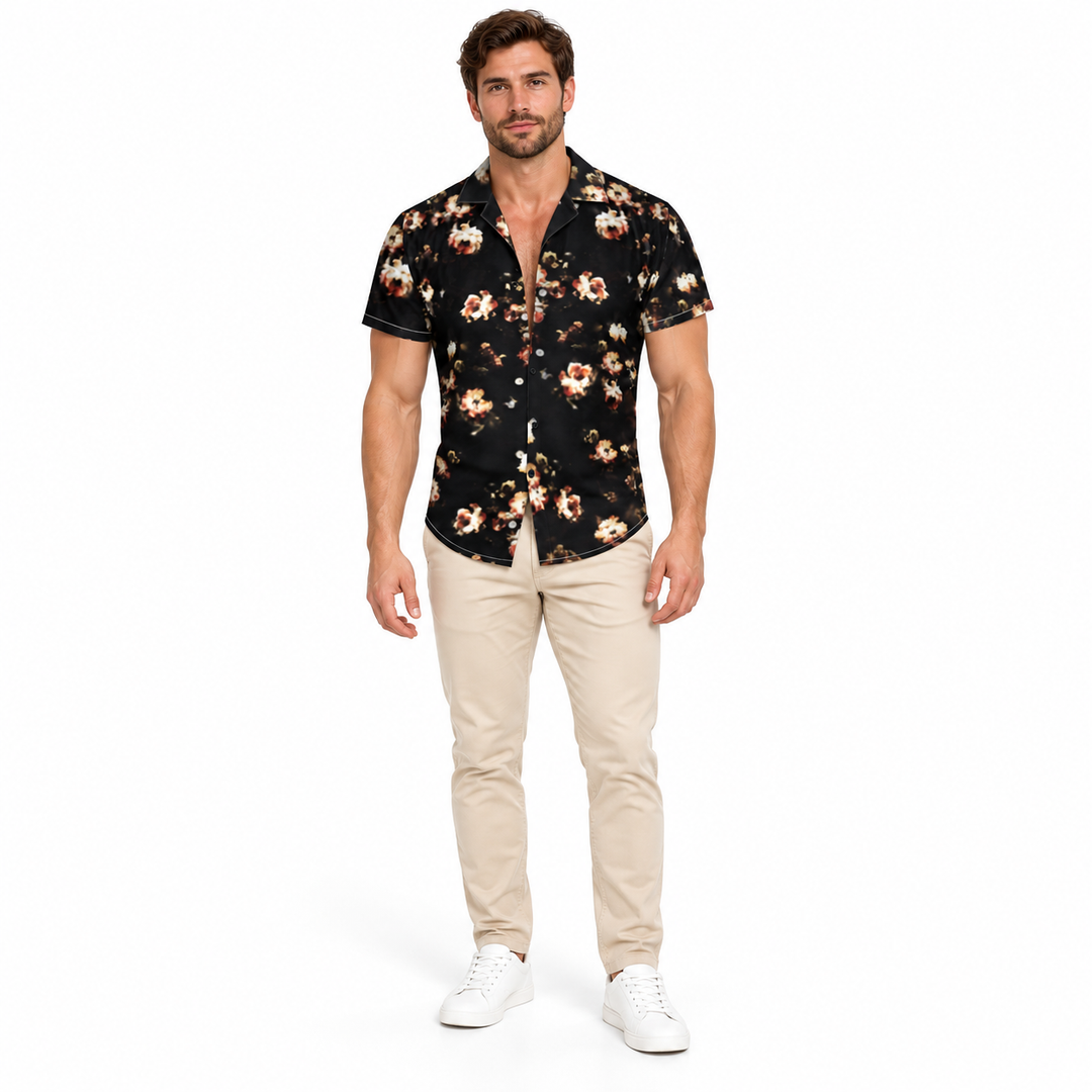 Adult model shown wearing the black and cream floral shirt with beige trousers and white sneakers on a white studio backdrop.