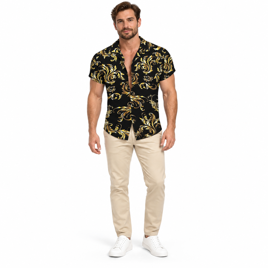 Male model shown wearing the black and gold scroll print collared shirt with beige trousers and white sneakers against white.