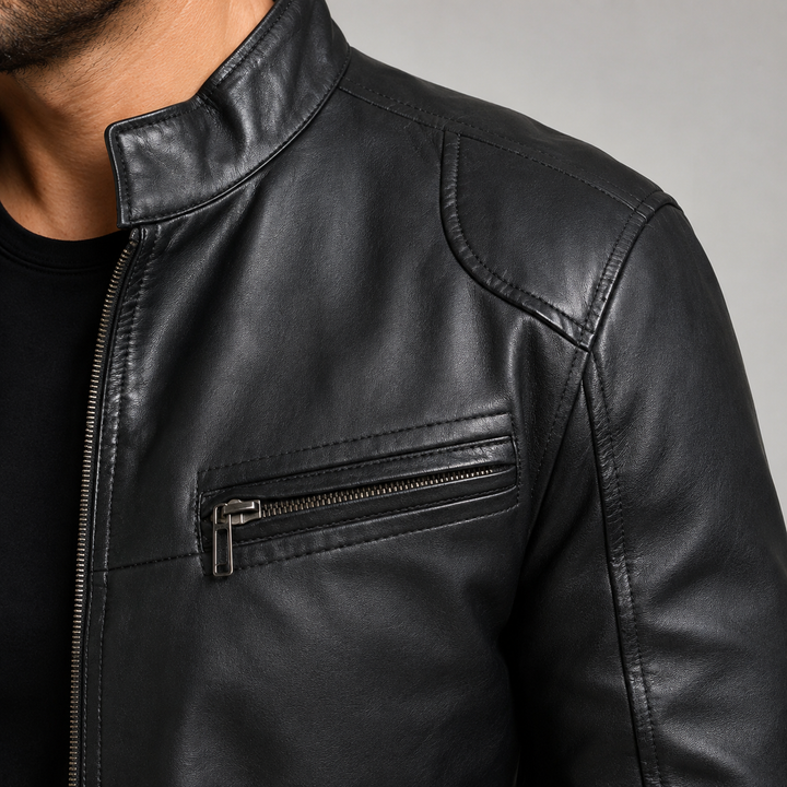 Close-up of black stand collar motorcycle leather jacket texture seams and stitching