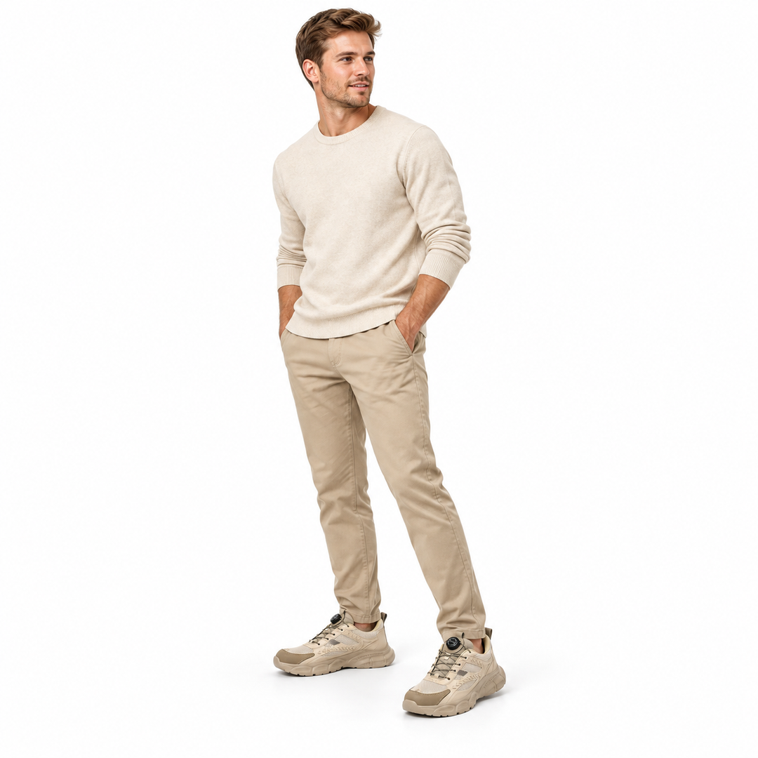 Adult male model wearing beige model 9233 shoes with neutral trousers and cream top, shown full length in white studio scene.