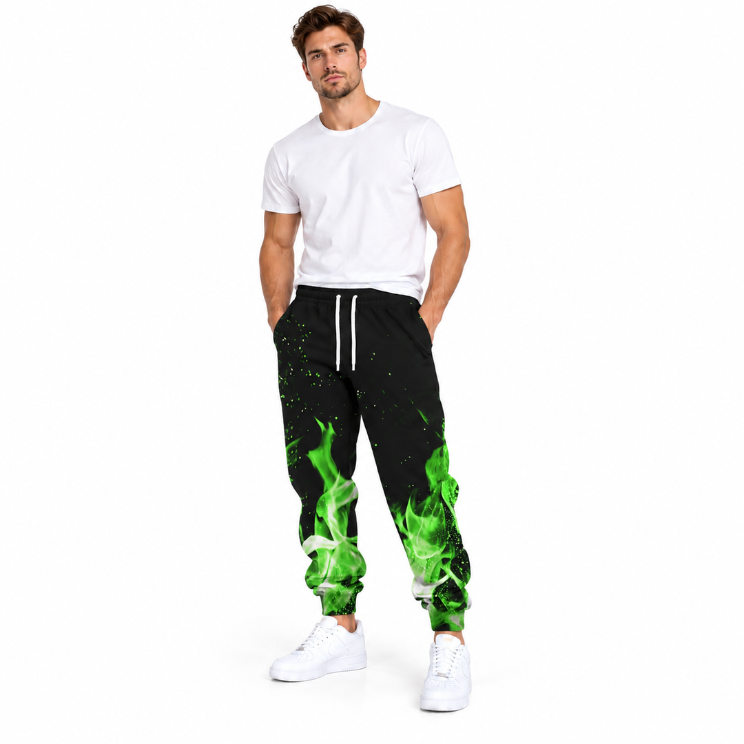 Male model wearing green flame drawstring pants, with a plain white T-shirt and white sneakers, on a white studio background.