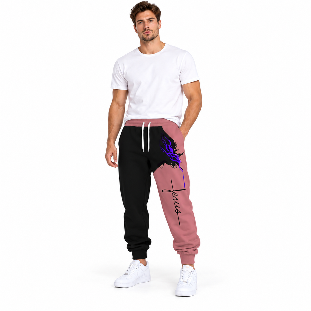 Male model wearing pink Jesus print drawstring pants, with a white tee and white sneakers, against a white studio background.