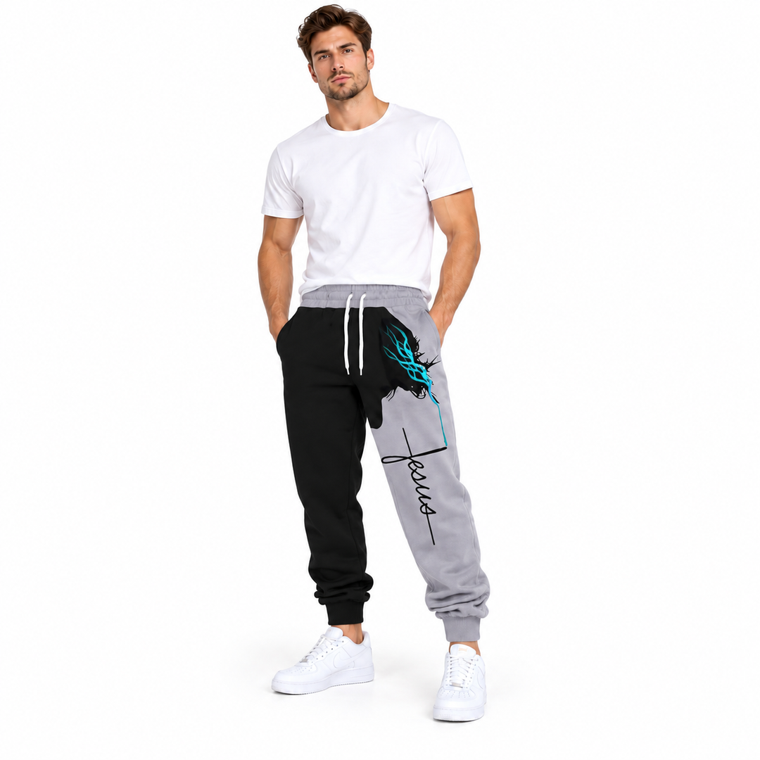 Male model wearing gray Jesus print drawstring pants, with a white tee and white sneakers, against a white studio background.