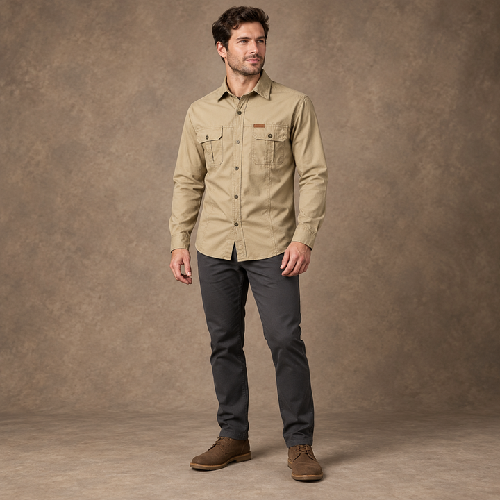Full-body model wearing a khaki long-sleeve utility shirt with two buttoned chest pockets.
