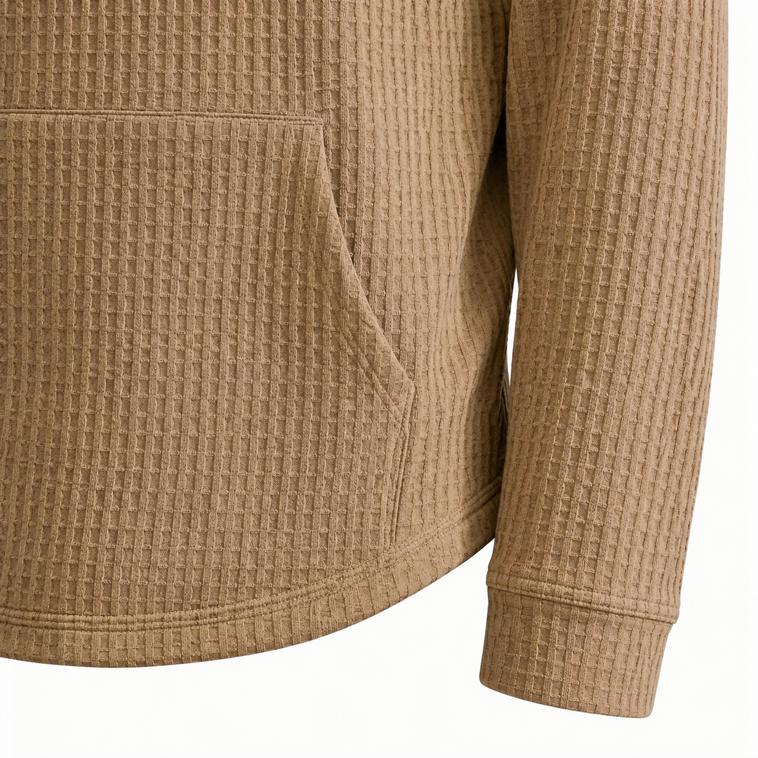 Khaki waffle knit hoodie close-up showing kangaroo pocket, cuff and curved hem finish.