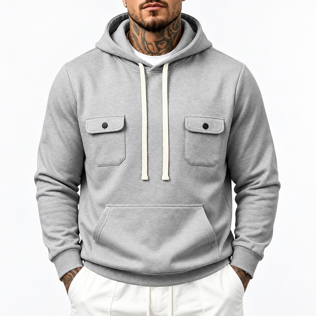 Close front view showing a gray hoodie with two flap chest pockets and a kangaroo pouch