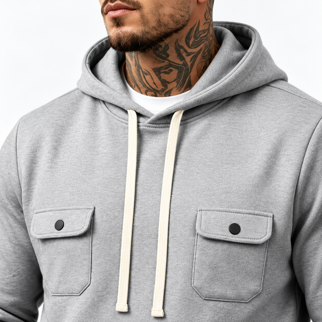Close-up of gray hood, white drawstrings and two flap chest pockets