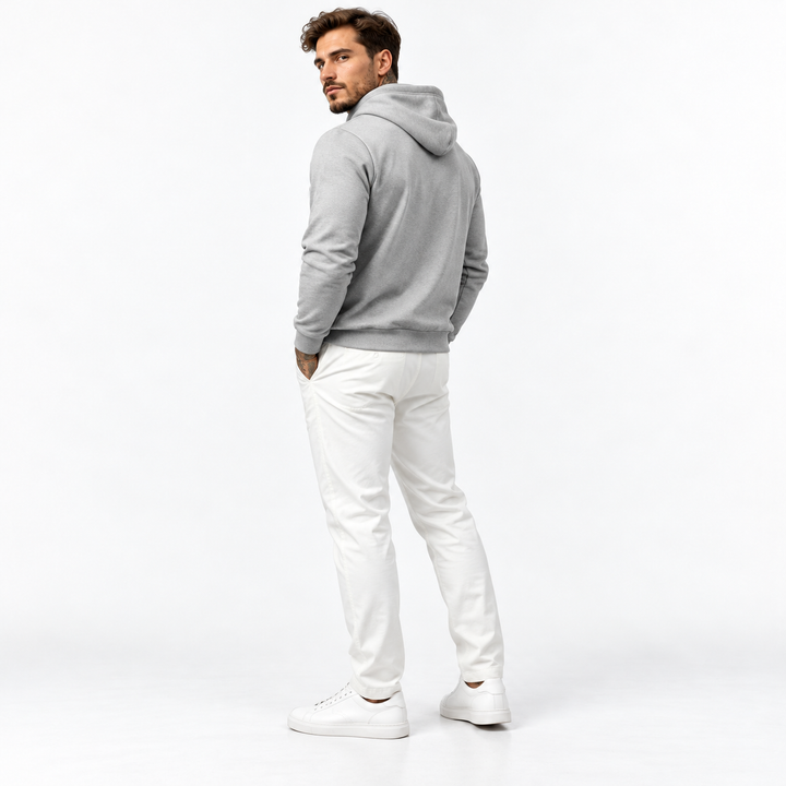 Male model wearing a gray pullover hoodie in a rear three-quarter pose