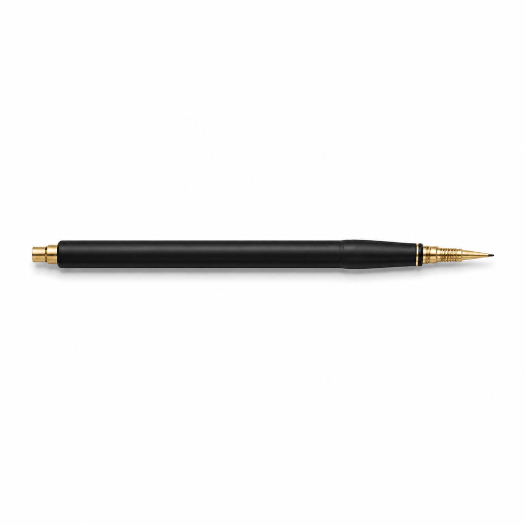 Black calligraphy pen side view with gold tip on white background