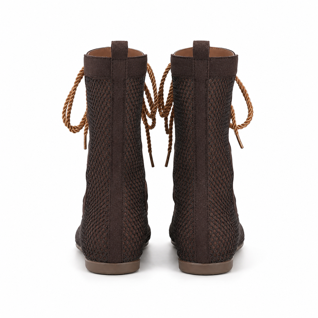 Back view of brown mid calf mesh boots showing the rear shaft, pull tabs, mesh panels and flat soles on white.