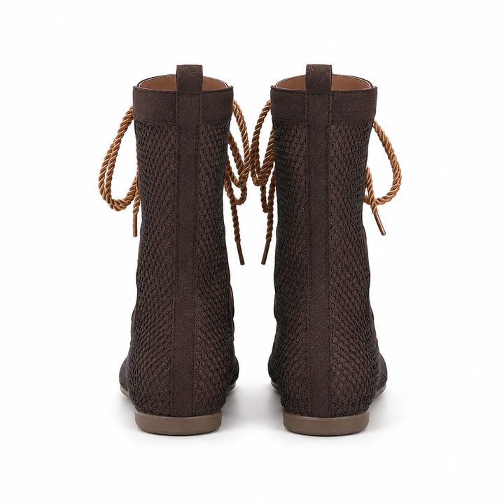 Back view of brown mid calf mesh boots showing the rear shaft, pull tabs, mesh panels and flat soles on white.
