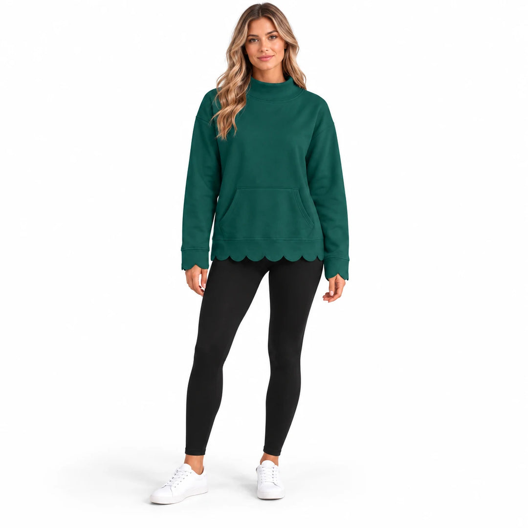 Full-body model in a dark green pullover with a mock collar, front kangaroo pocket and scalloped edges, on a white background