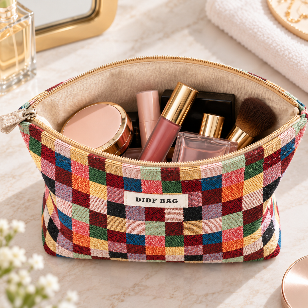 Open Multicolor Plaid cosmetic bag showing the cream canvas lining, beige zipper and cosmetics inside.
