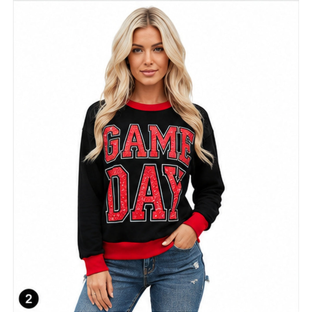 Women's black GAME DAY sweatshirt shown on a model against a clean white studio background with red ribbed trim visible.
