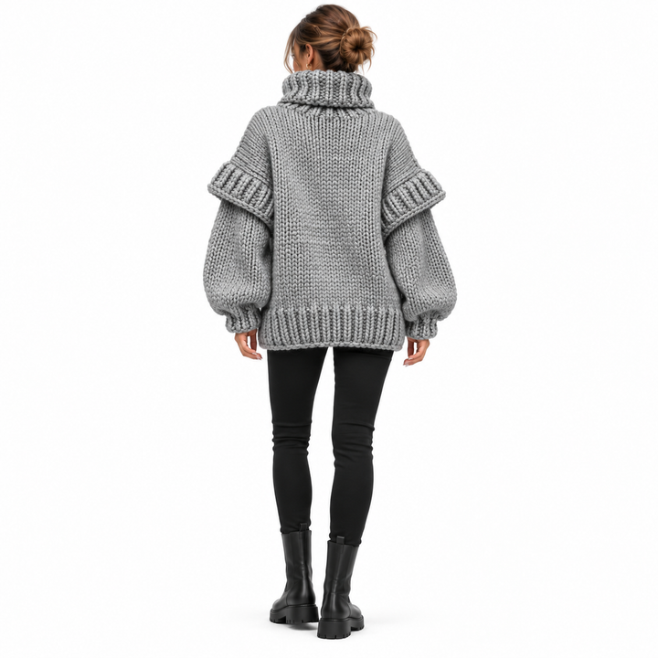 Gray chunky knit turtleneck sweater on model, full back view