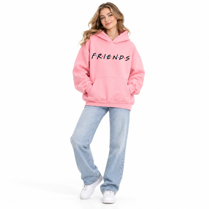 Full-body female model wearing pink letter-print hooded pullover with jeans and white shoes