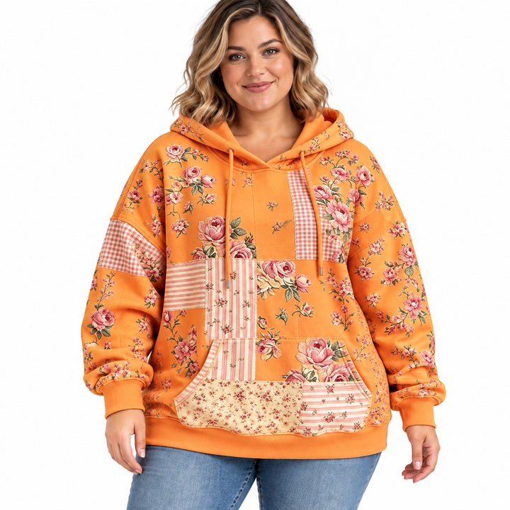 Plus size floral hoodie in tangerine with drawstrings and a kangaroo pocket, shown on a model against white