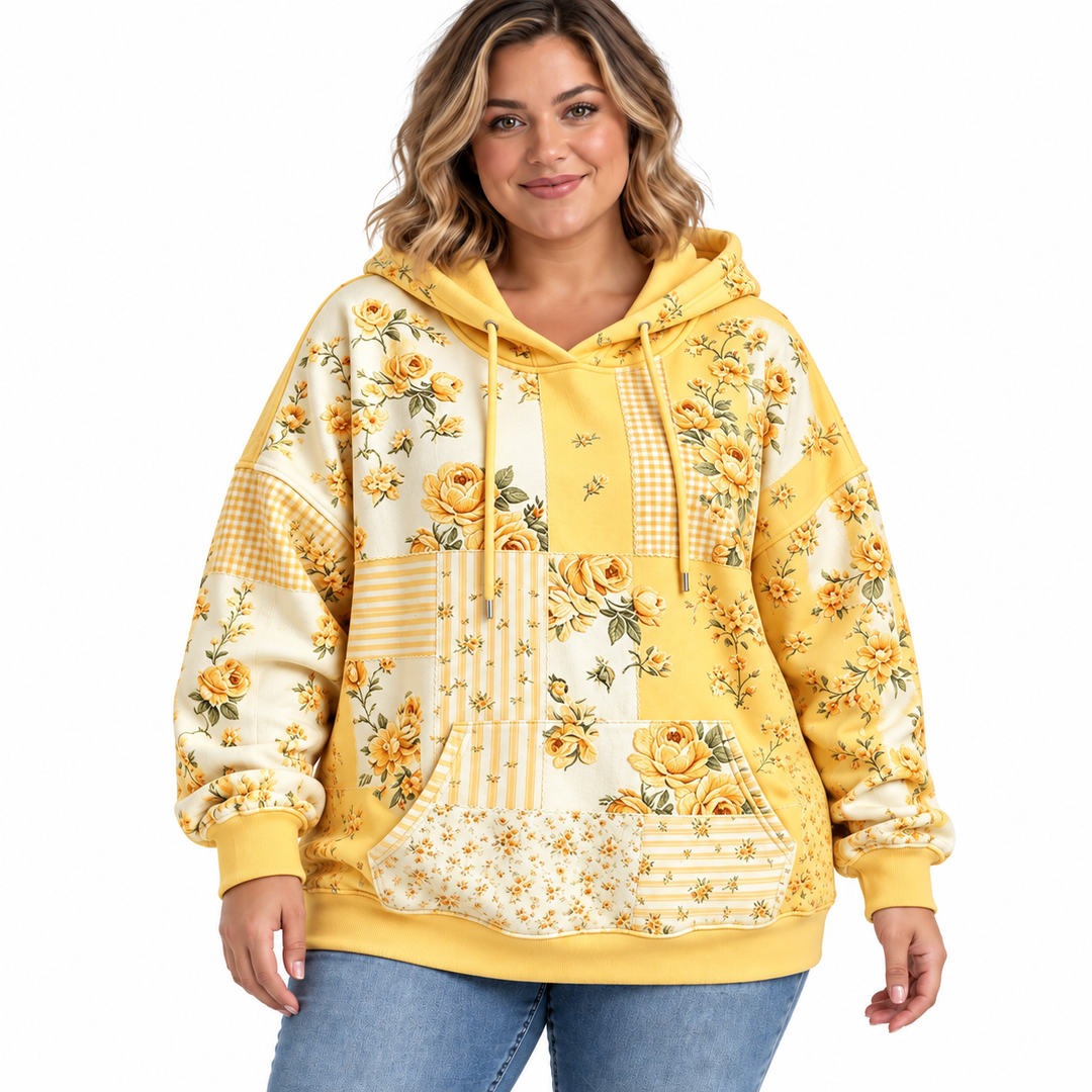 Plus size floral hoodie in yellow with drawstrings and a kangaroo pocket, shown on a model against white