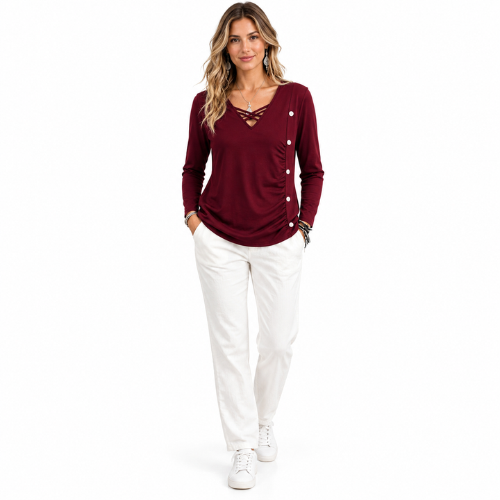 Burgundy top with side buttons styled with white trousers