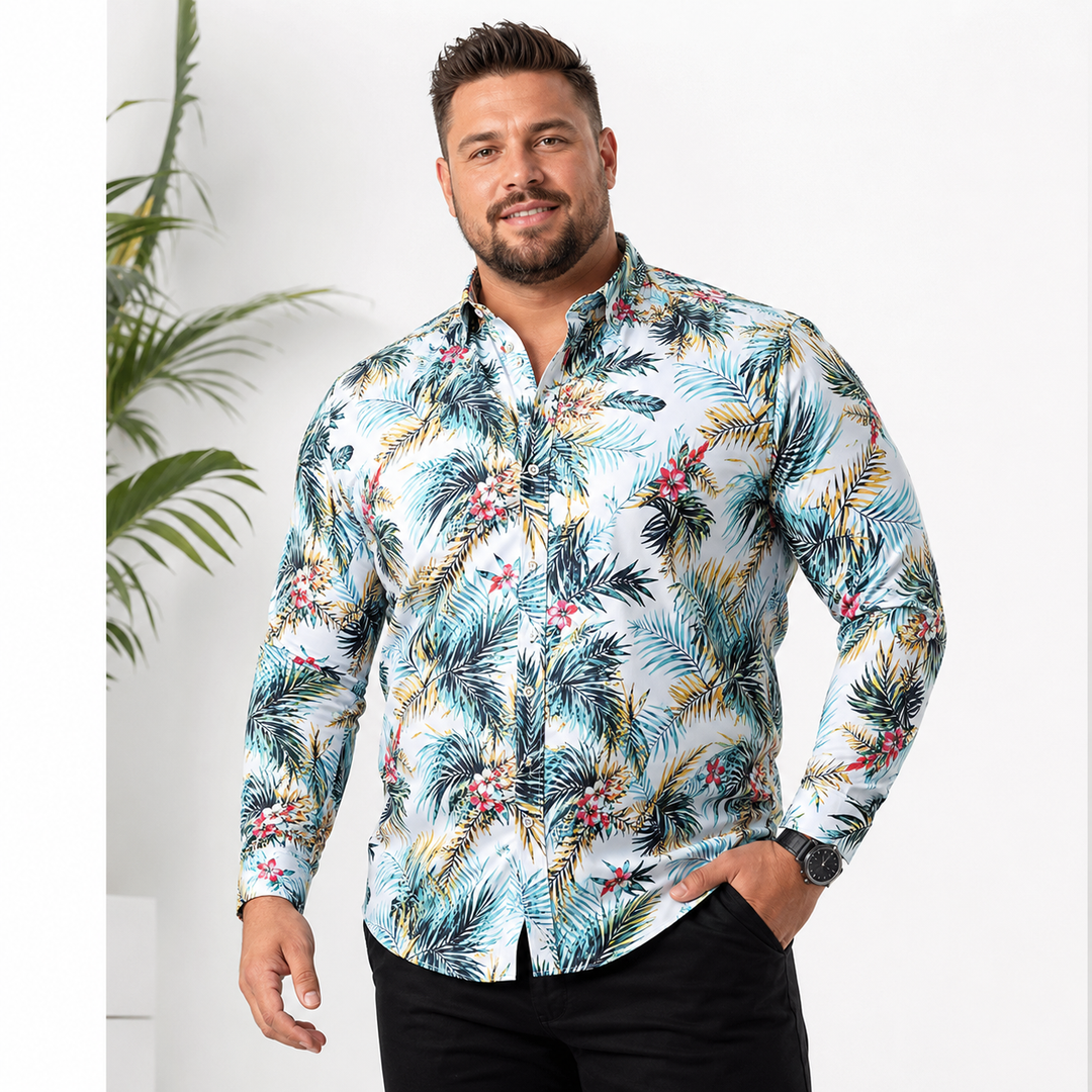 Male model wearing a light blue tropical floral long sleeve shirt, styled for a clean commercial studio product presentation.